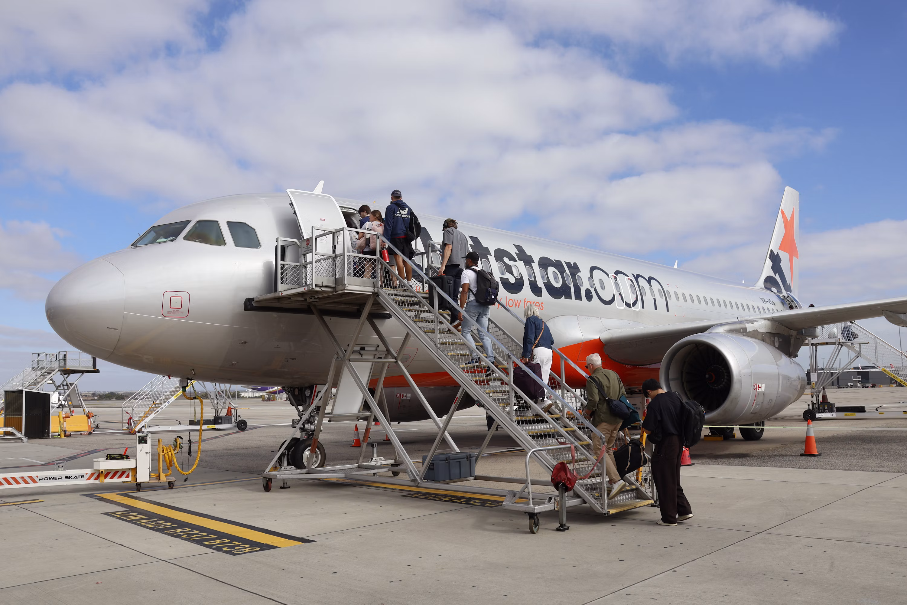Passengers boarding aircraft at Melbourne Airport Australia